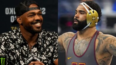 Jon Jones appears at a UFC 285 press conference, opposite Gable Steveson at the 2025 NCAA Wrestling Championships