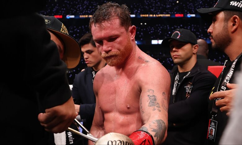 Canelo Alvarez gets the tape cut off his gloves after a loss to Terence Crawford