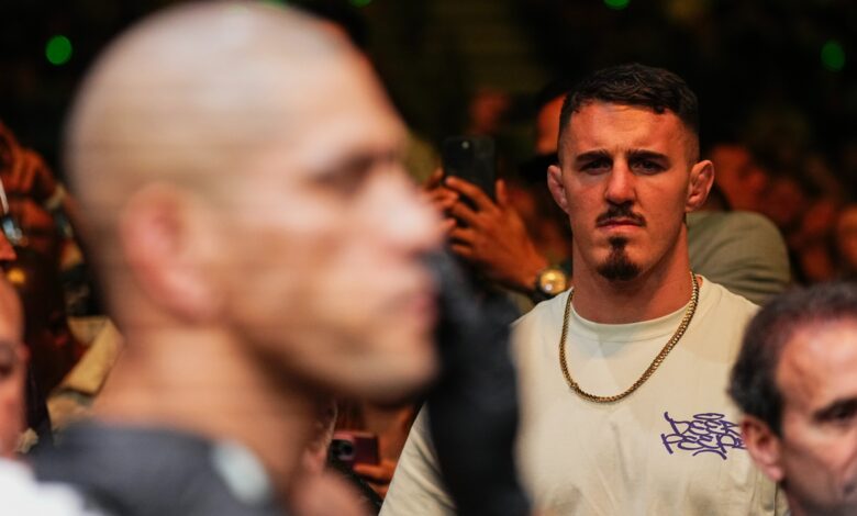 Tom Aspinall looks on after Alex Pereira wins at UFC 300
