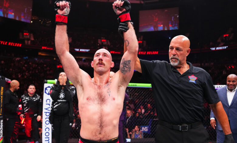 Dan Miragliotta raises Kyle Nelson's arm at UFC Vancouver