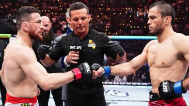 Merab Dvalishvili and Umar Nurmagomedov touch gloves just before their UFC 311 title fight