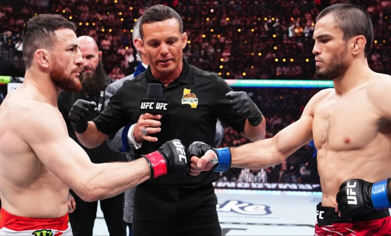 Merab Dvalishvili and Umar Nurmagomedov touch gloves just before their UFC 311 title fight