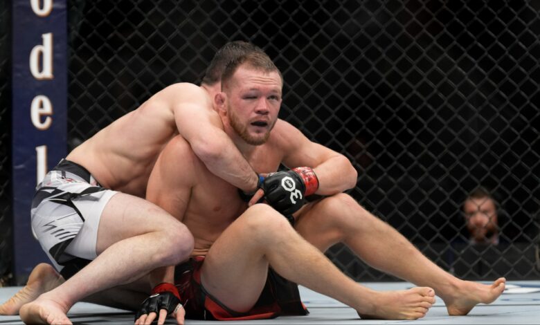 Merab Dvalishvili grapples with Petr Yan during their fight in Las Vegas