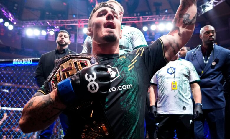 Tom Aspinall celebrates after winning the UFC interim heavyweight title at UFC 295