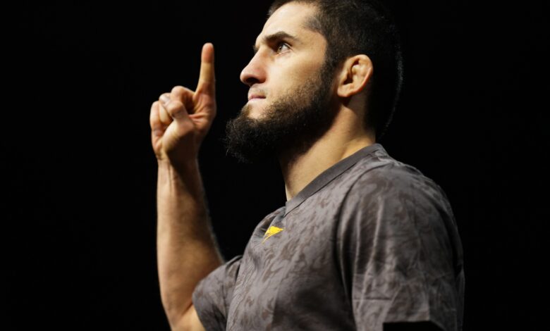 Islam Makhachev poses on the scale at the UFC 311 ceremonial weigh-in