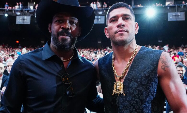 Alex Pereira and Jon Jones pose for a photograph at UFC 306