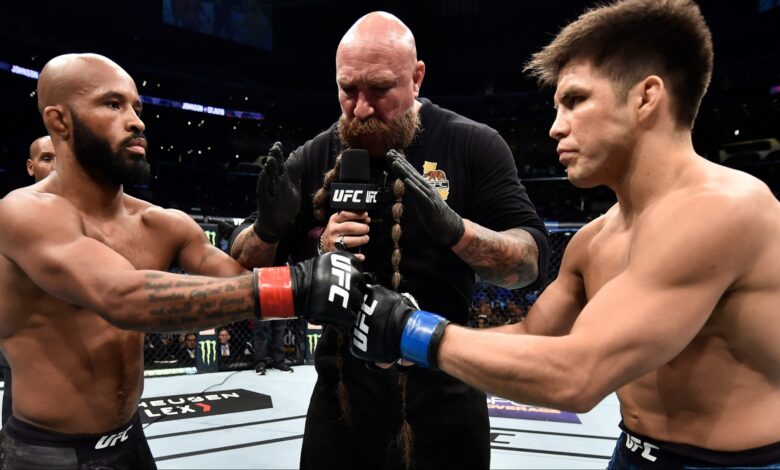 Demetrious Johnson and Henry Cejudo touch gloves just before their fight