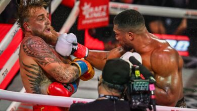 Anthony Joshua punches Jake Paul during their boxing match