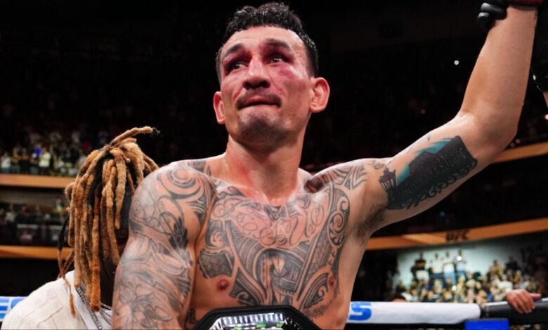 Max Holloway celebrates after his win over Dustin Poirier at UFC 318