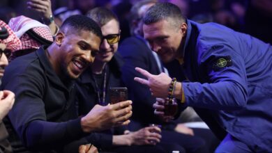 Oleksandr Usyk and Anthony Joshua take a photo ringside at a Riyadh Season event