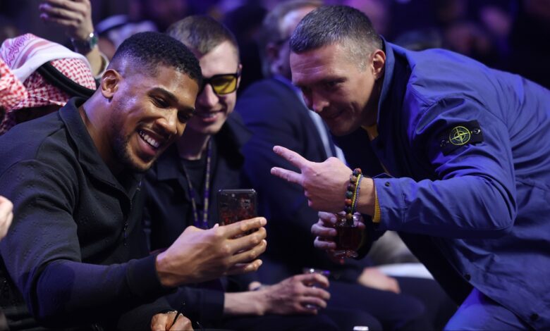 Oleksandr Usyk and Anthony Joshua take a photo ringside at a Riyadh Season event