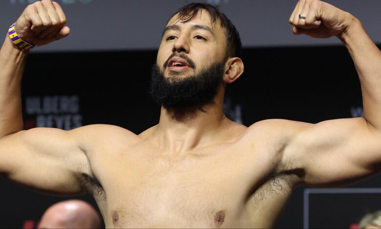 Dominick Reyes poses on the scale during the UFC Perth ceremonial weigh-in