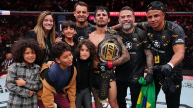 Alexandre Pantoja poses for a photo with his family after his win at UFC 296
