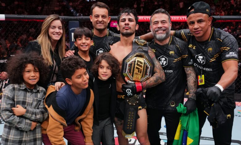 Alexandre Pantoja poses for a photo with his family after his win at UFC 296