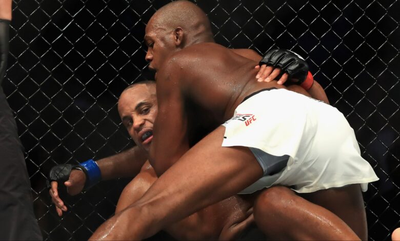 Jon Jones grapples with Daniel Cormier during their fight at UFC 214